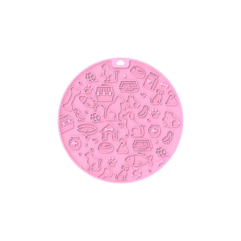 Round silicone pet licking mat with suction cup base in blue, on a kitchen tile floor.