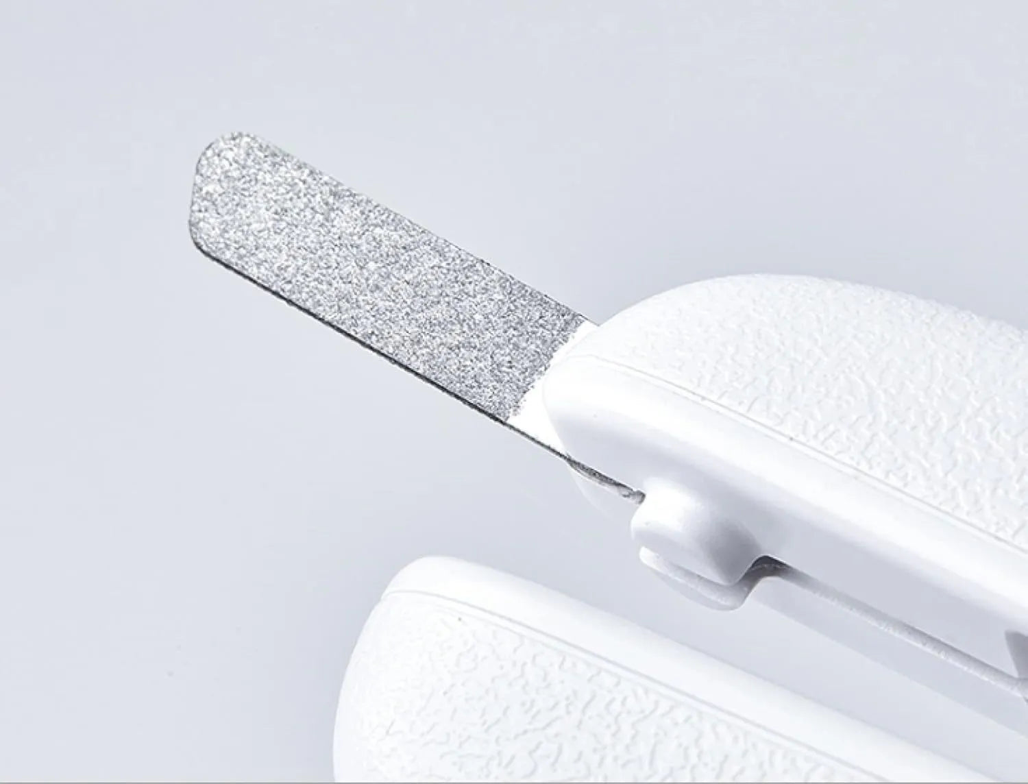 White pet nail clippers with LED light, triangular blade, and transparent anti-splash guard