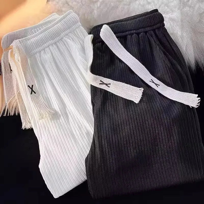 Men's loose straight cotton casual trousers in white, front view, on a model