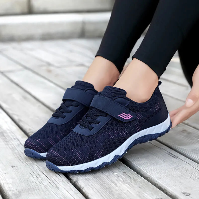 Women's grey purple low top wedge heel shoes with velcro strap and mesh upper.