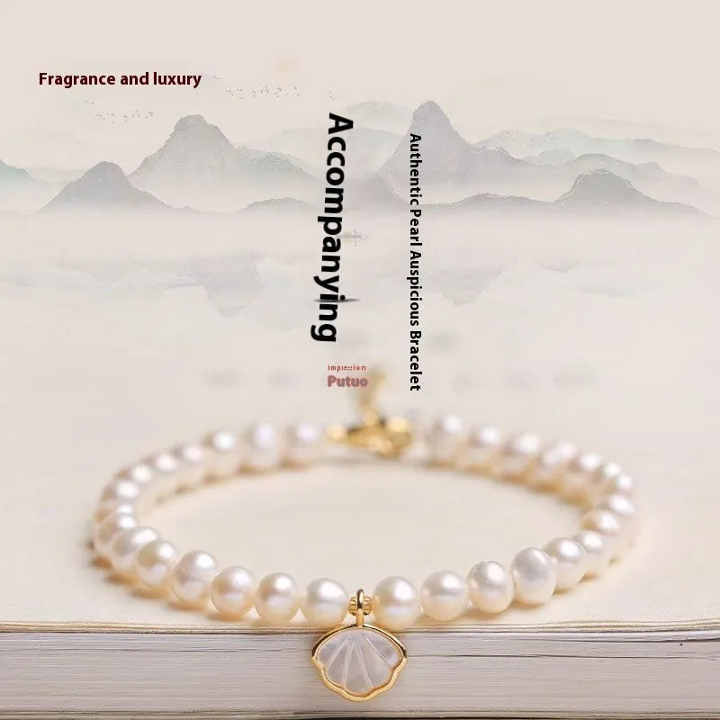 Women's freshwater pearl bracelet with fan-shaped design and alloy shell clasp, showing elastic string and extension chain options.