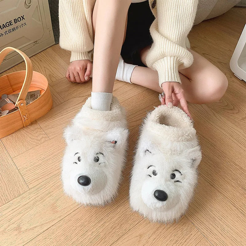 Pair of grey ankle wrap cotton slippers with plush upper and artificial wool lining on a home floor