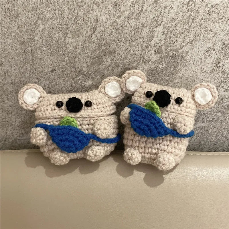 Hand-knitted koala bear backpack design cover for Apple AirPods charging case on a white background.