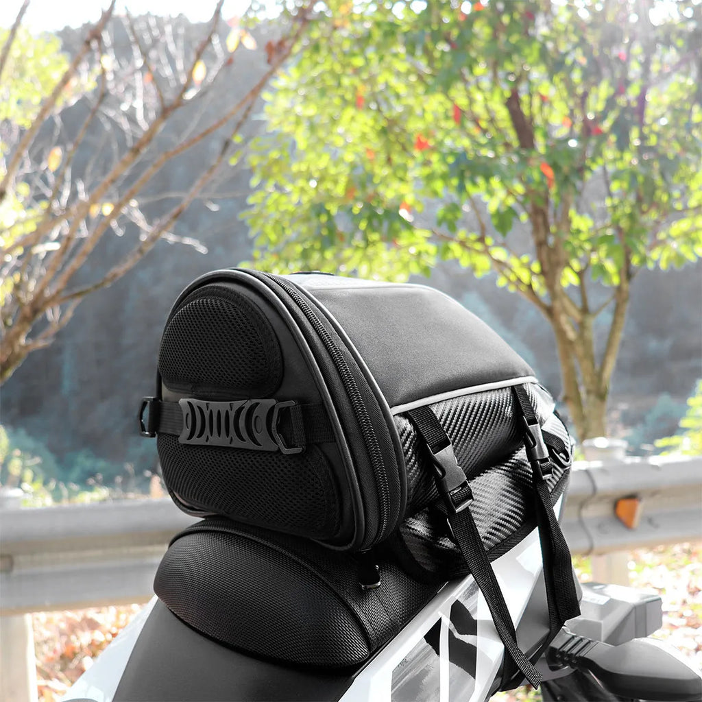 Black motorcycle fuel tank bag with reflective stripe, 15-litre capacity, mounted on a motorcycle seat
