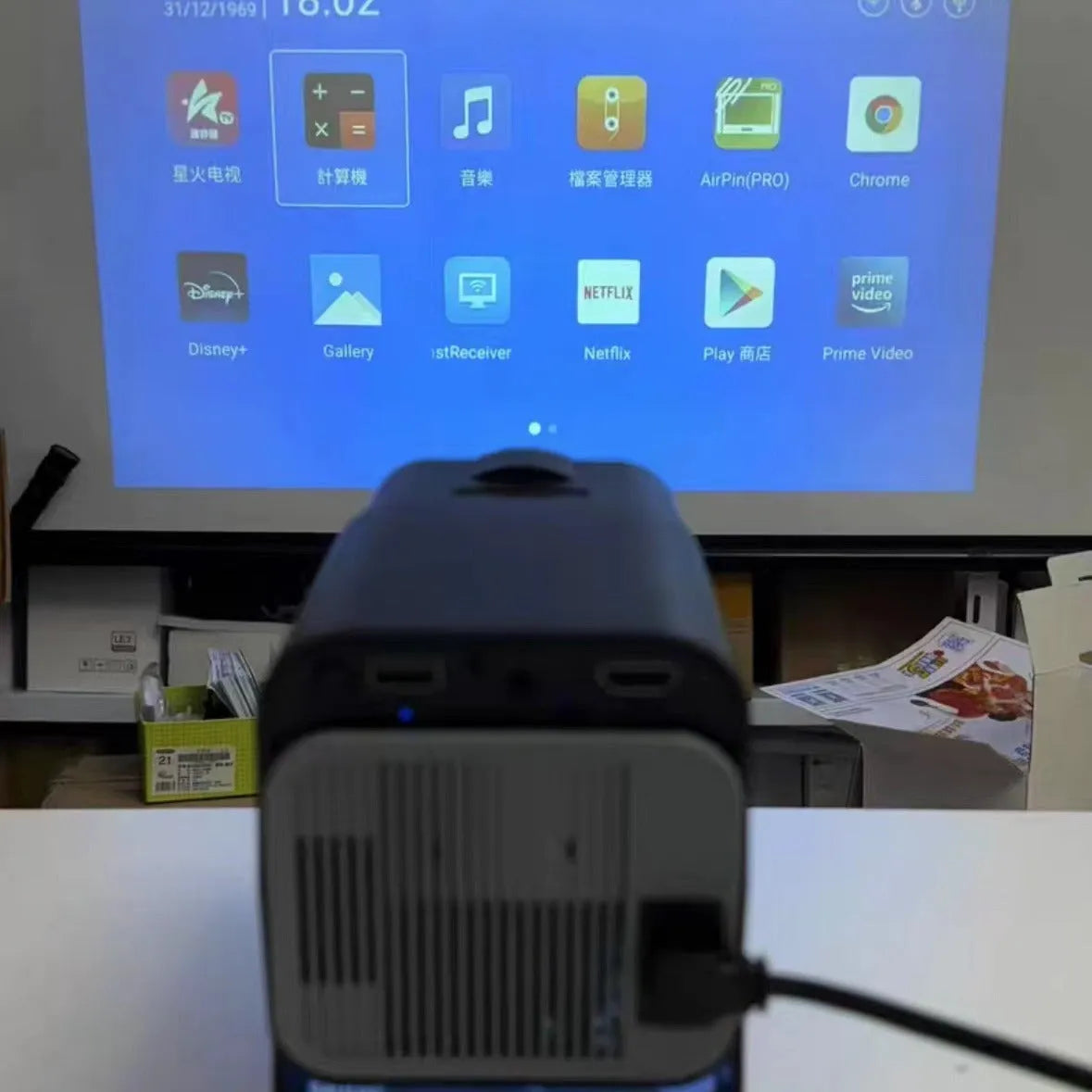 White HD wireless projector with handle showing 720p resolution capability and multi-standard power support for home gaming