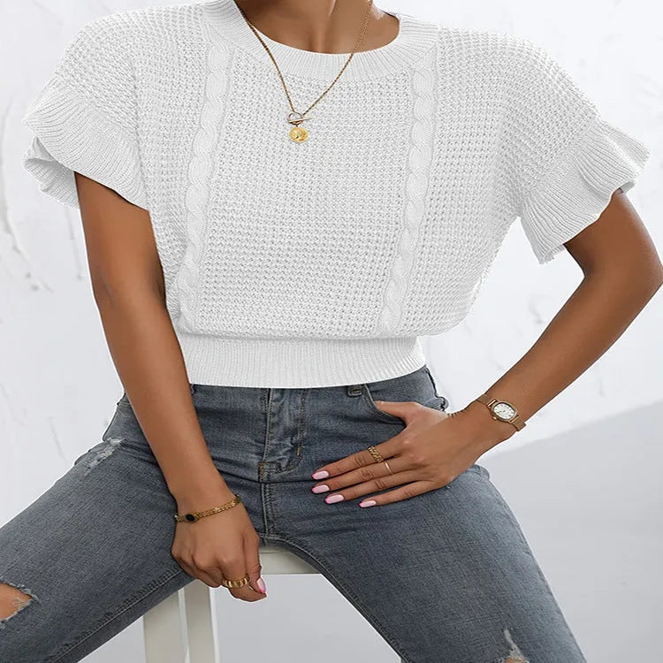 Loose fit knitted pullover with round neck and textured ruffled short sleeves in a neutral colour.