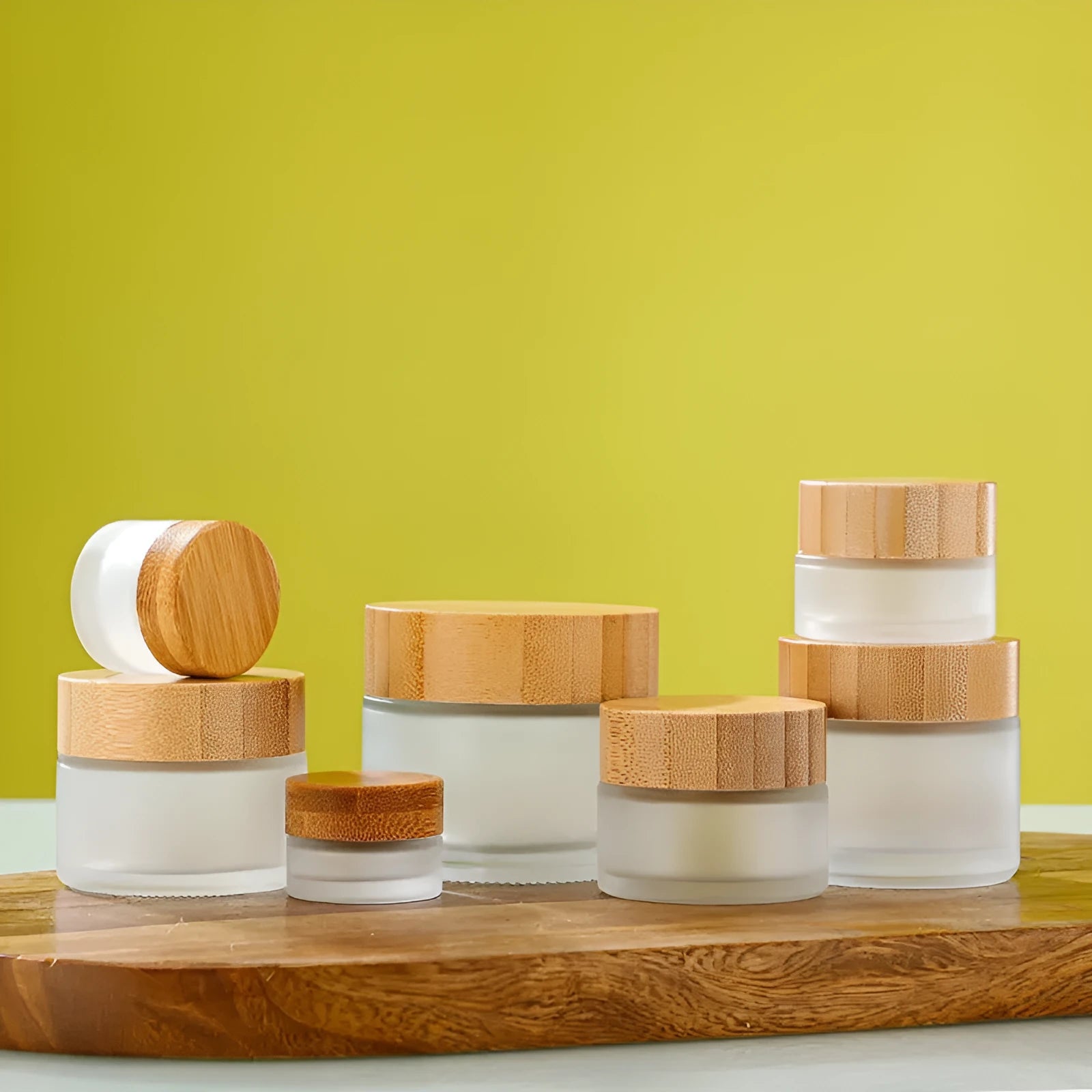 Glass sub-bottle with bamboo wood cover for travel cream in 50g size, transparent finish