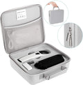 Hand-held red light therapy device in black and white with LED array, USB cable, and safety glasses on a surface