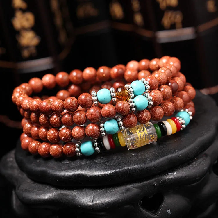 Golden star stone and nugget sand multi-circle bracelet with fu character on a retro-style chain.