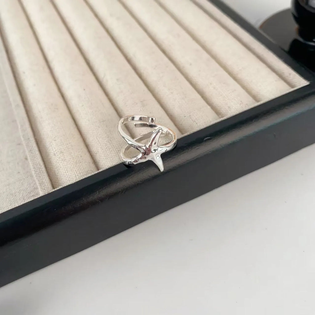 Three-dimensional jasmine and camellia flower ring with open-mouth design on zinc alloy.