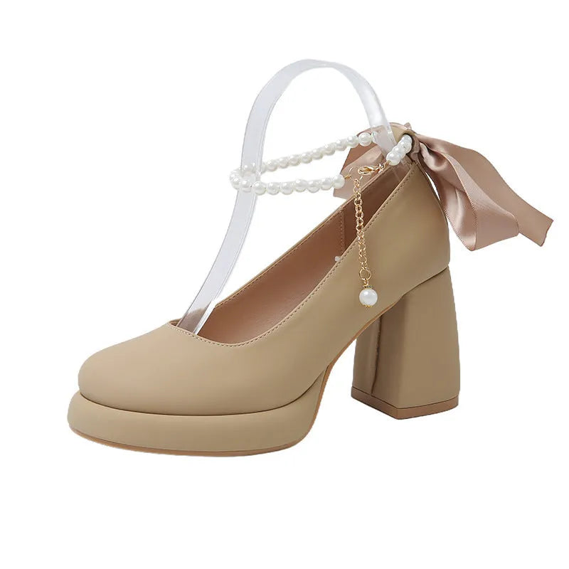 Beige women's Mary Jane shoes with chunky heel, ankle strap buckle, and pearl decoration on round toe
