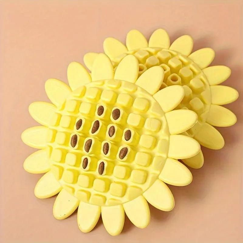 Yellow rubber sunflower dog chew toy on a surface, non toxic and BPA free for puppy teething