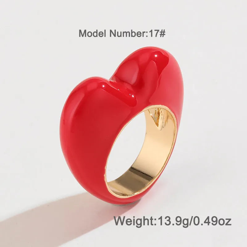 Three-dimensional heart-shaped enamel ring in multiple colours on a zinc alloy band.