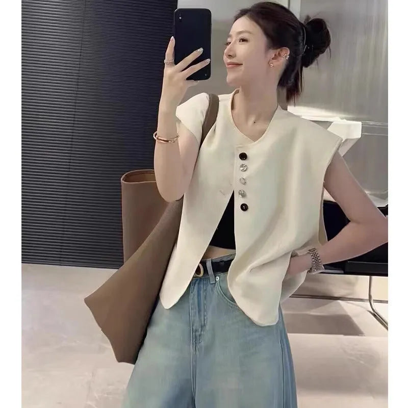 Women's loose fit polyester vest in milky white colour with pockets.