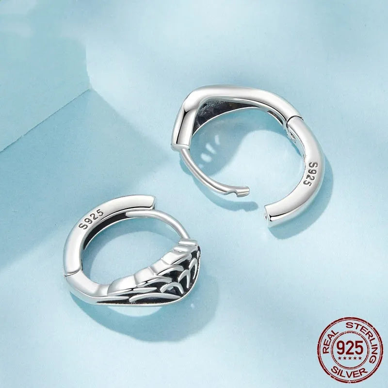 Pair of vintage S925 sterling silver wings ear clip earrings in silver colour on white background