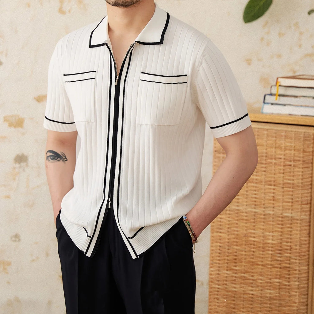 Slim fit black short-sleeved polo shirt with a lapel collar, made from a viscose and polyester knit fabric.