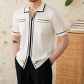 Slim fit black short-sleeved polo shirt with a lapel collar, made from a viscose and polyester knit fabric.