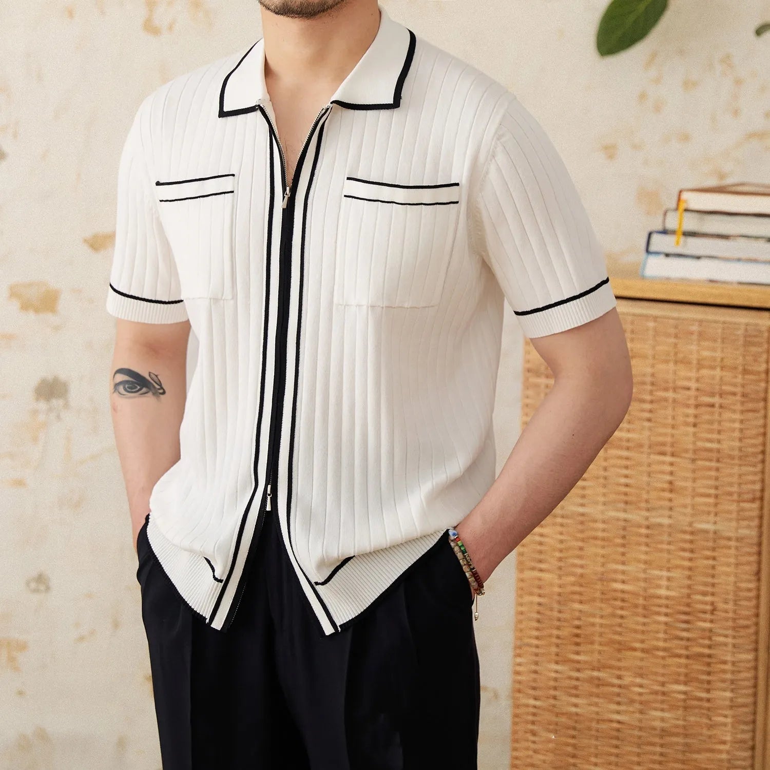Slim fit black short-sleeved polo shirt with a lapel collar, made from a viscose and polyester knit fabric.