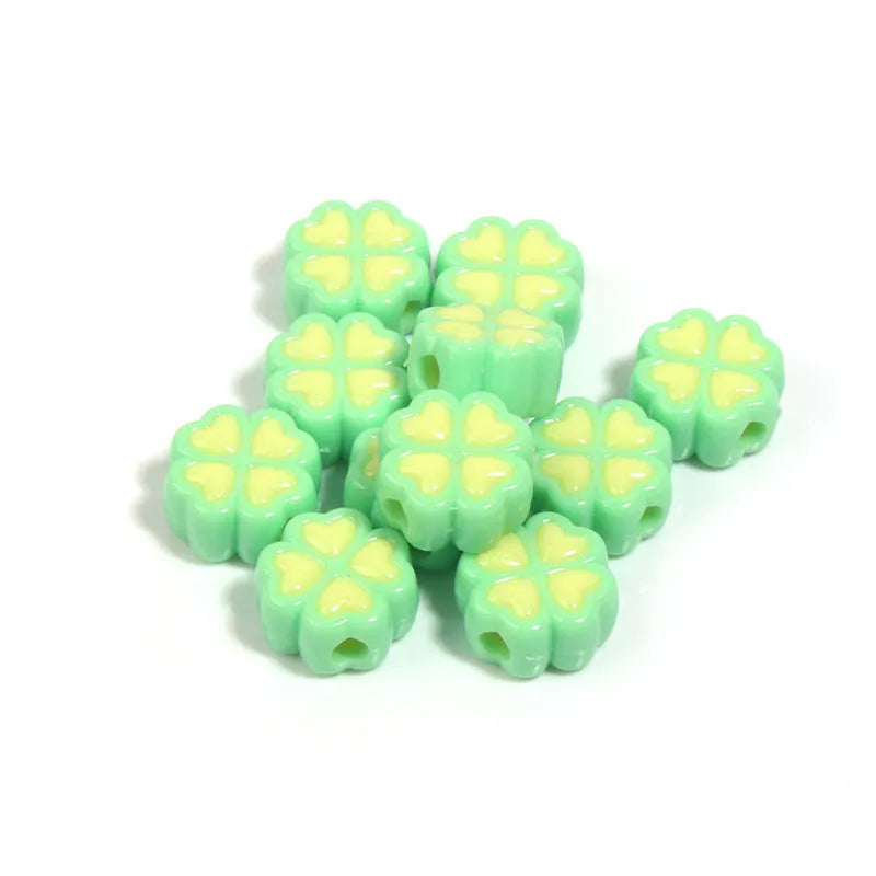 Acrylic four-leaf clover craft beads with love pattern in mixed colours showing frosted finish