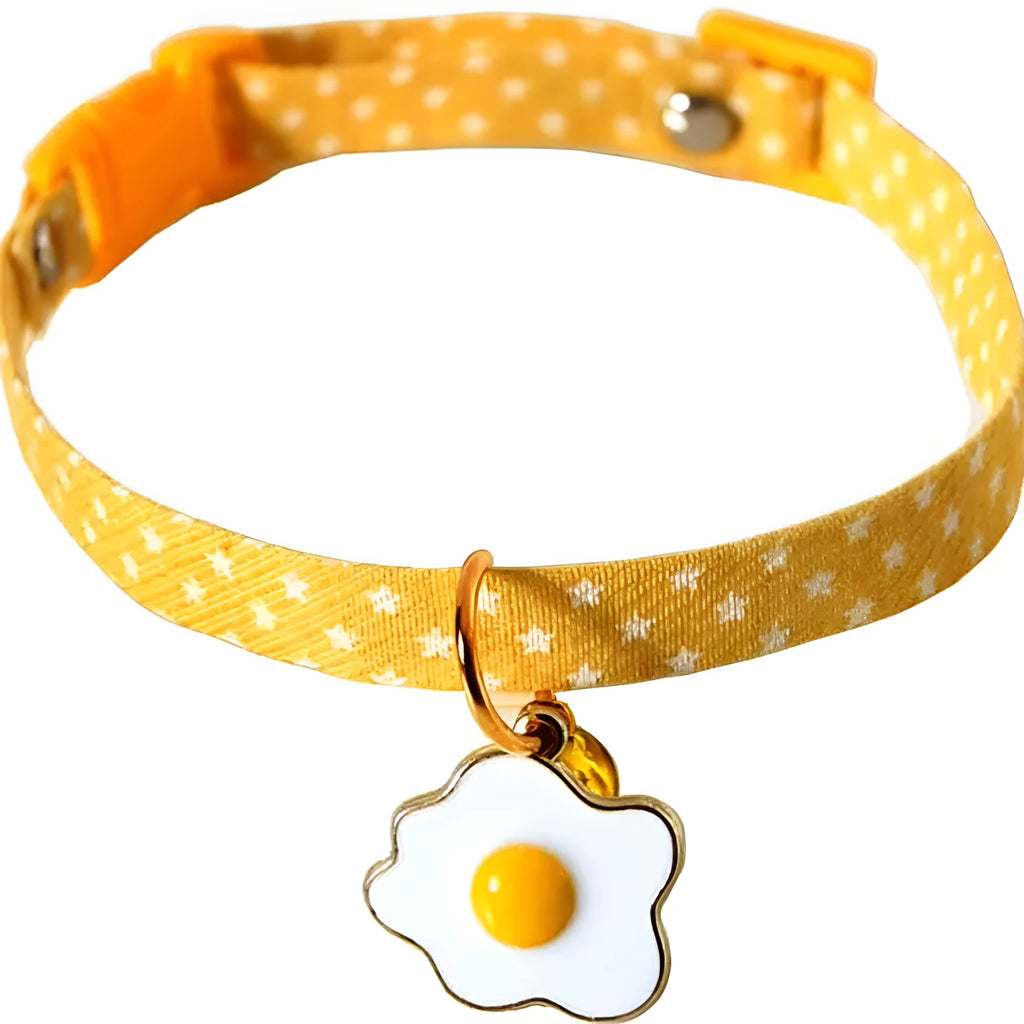 Green adjustable cat collar with a metal bell and red bow tie on a white background.