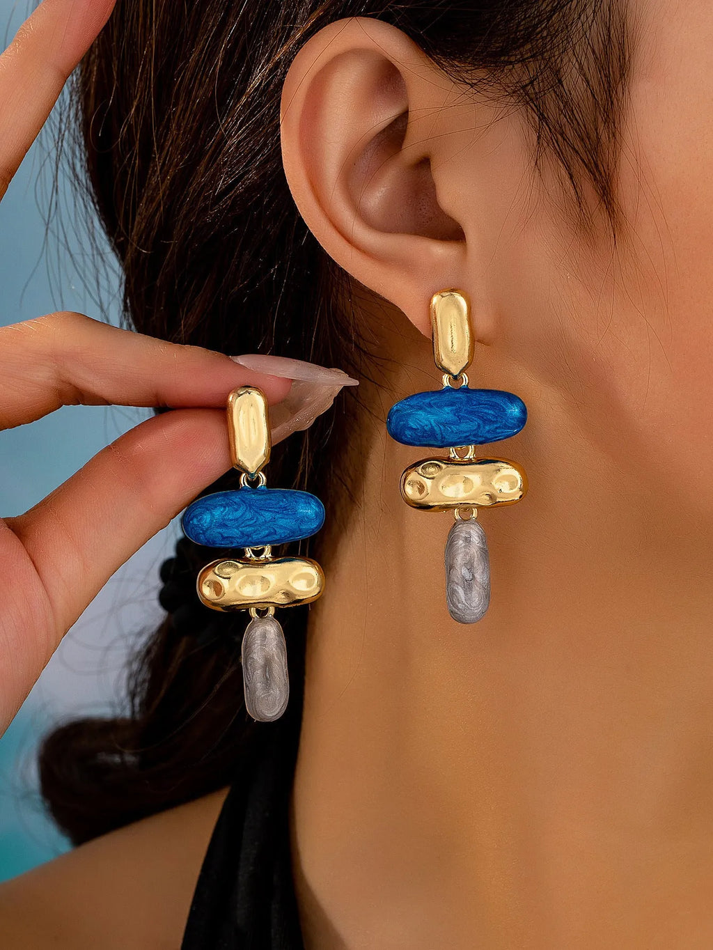 A pair of simple geometric stud earrings with a multicolour metallic electroplated finish.