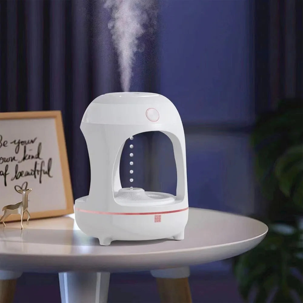 Anti gravity levitating water drops humidifier with LED night light, rose gold white, on desk