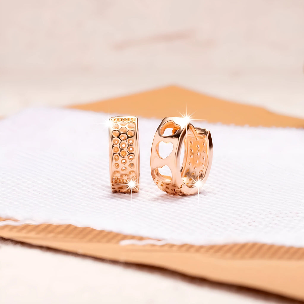 Rose gold electroplated women's earrings with hollow heart-shaped design and circular overall shape