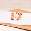 Rose gold electroplated women's earrings with hollow heart-shaped design and circular overall shape