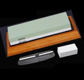 Double-sided white corundum kitchen whetstone 3000/8000 grit with bamboo base and knife holder locator on white background