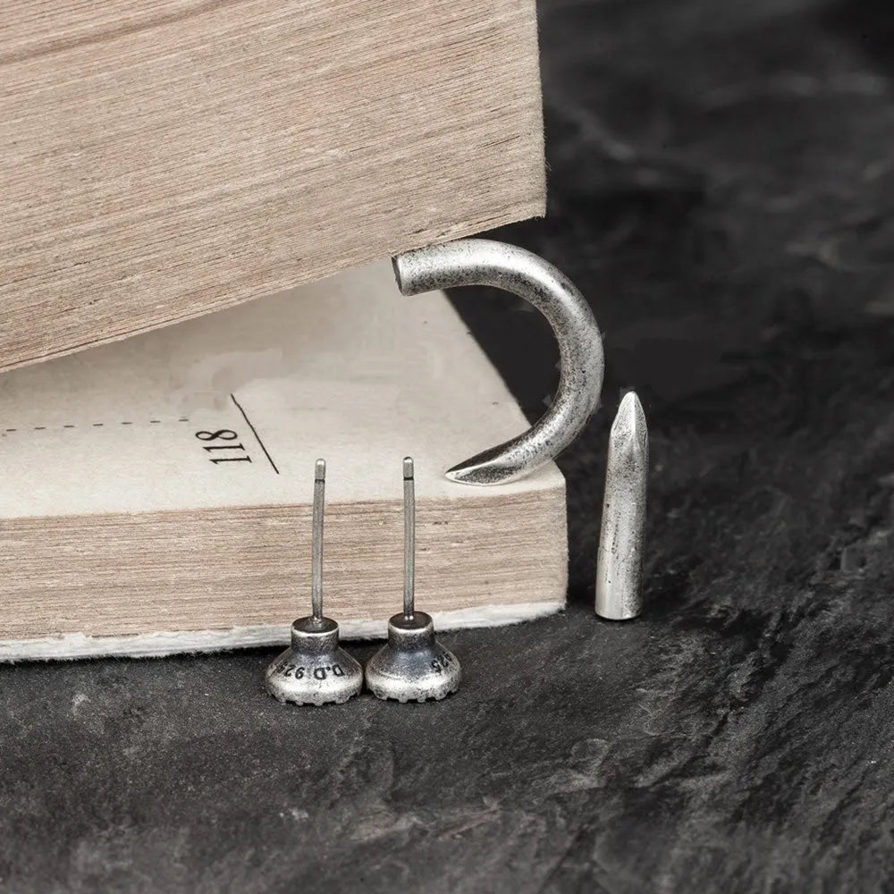S925 sterling silver punk stud earring in straight nail or curved nail design on a hook.