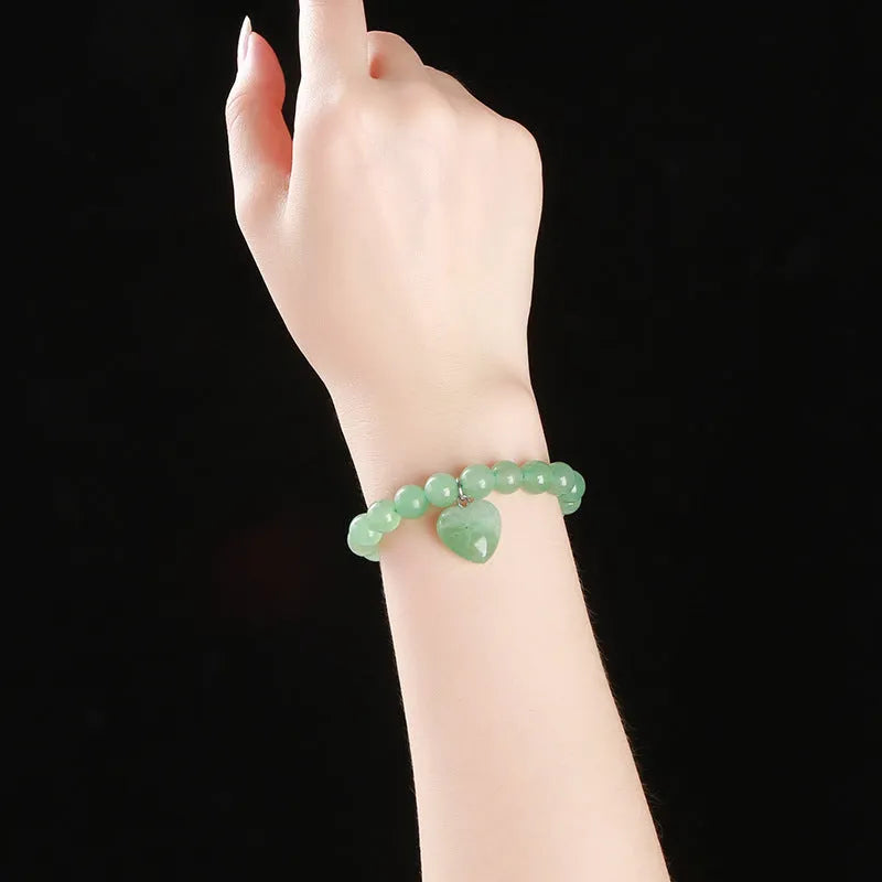 Natural stone love pendant hand bracelet with tigereye beads and geometric heart pendant on white background