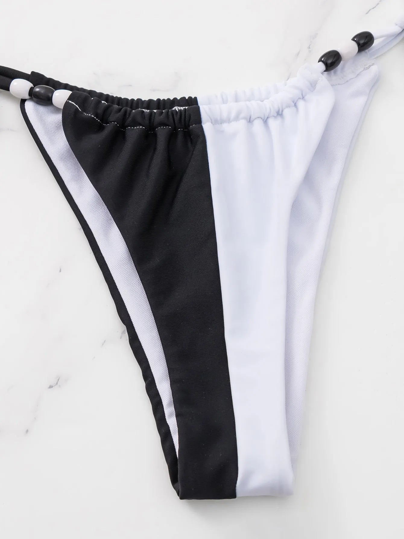 Women's black and white lace-up triangle cup bikini set with adjustable front ties