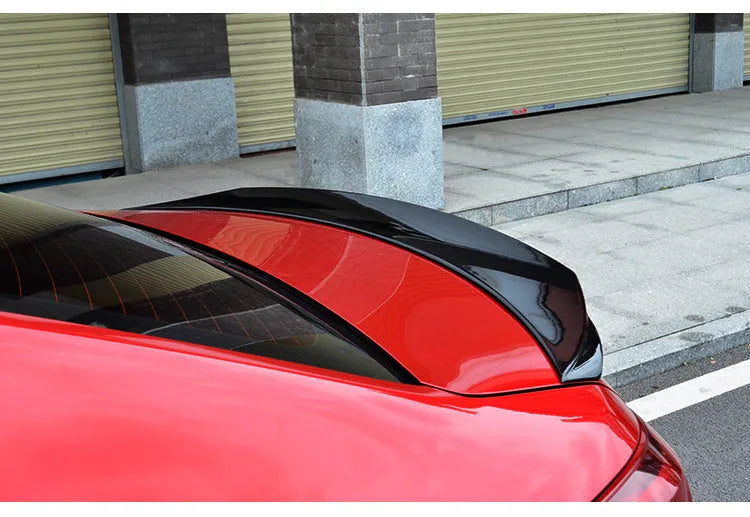Bright black Mazda 3 Axela Exela tail trim for 2014-2021 models showing sports tail blade design