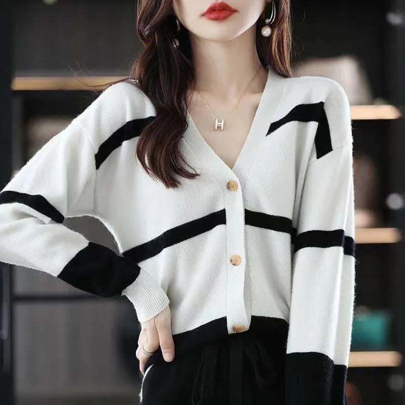 Women's black and white 3D striped knitted cardigan with button front and V-neck on a slim fit.