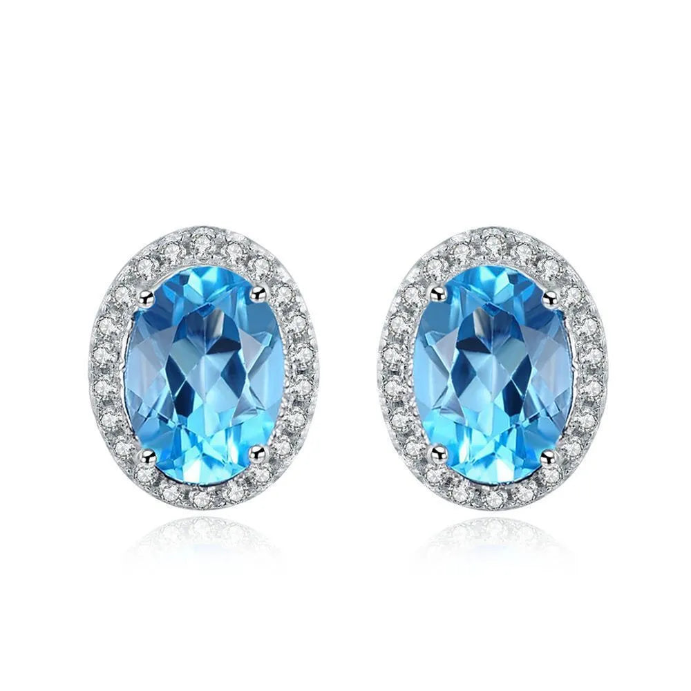 925 sterling silver jewellery set with blue topaz gems showing earrings, ring, pendant, and necklace with geometric design