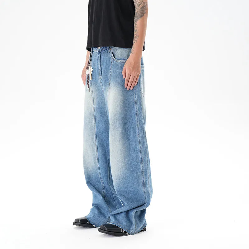 Cut washed vintage washed wide leg machete jeans in light blue denim with zipper fly, front view