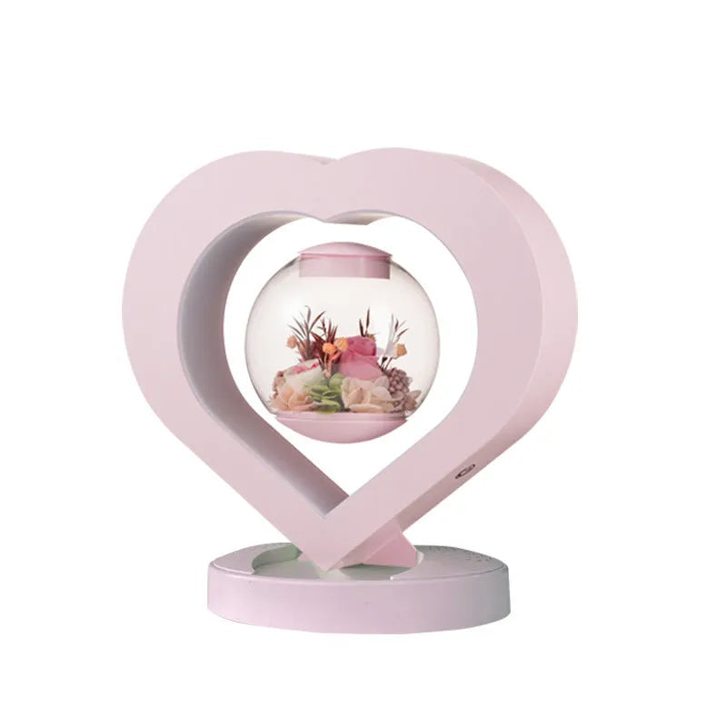 Pink preserved rose in ABS PC PVC ornament with Bluetooth base on tabletop