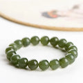 Polished Hetian jade ball bracelet in ice-like clear water colour on a wrist, showing bead detail.