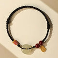10mm Hetian jade peace buckle bracelet with colourful braided rope on wrist
