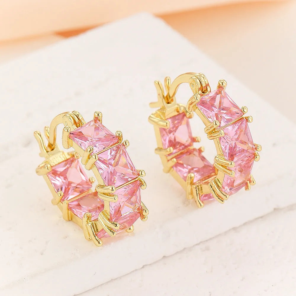 Geometric U-shaped gold earrings with round black zircon crystals