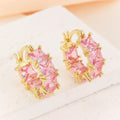 Geometric U-shaped gold earrings with round black zircon crystals