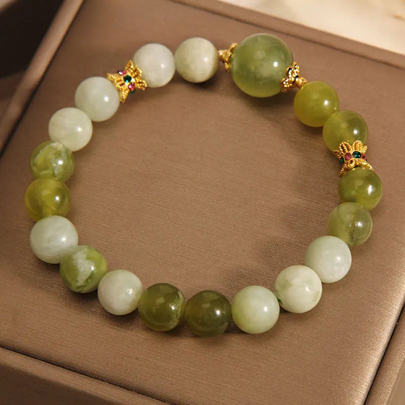 Women's bracelet in Xiuyan jade green with original design on display
