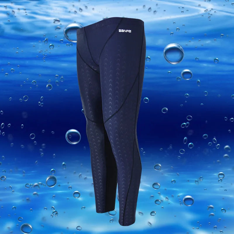 Men's nylon swimming trunks in black with grey trim, showing cropped brief style with mesh lining