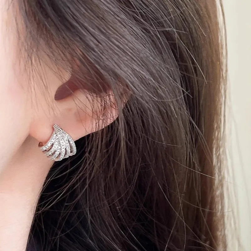 Platinum-coloured geometric line design earrings with zircon construction