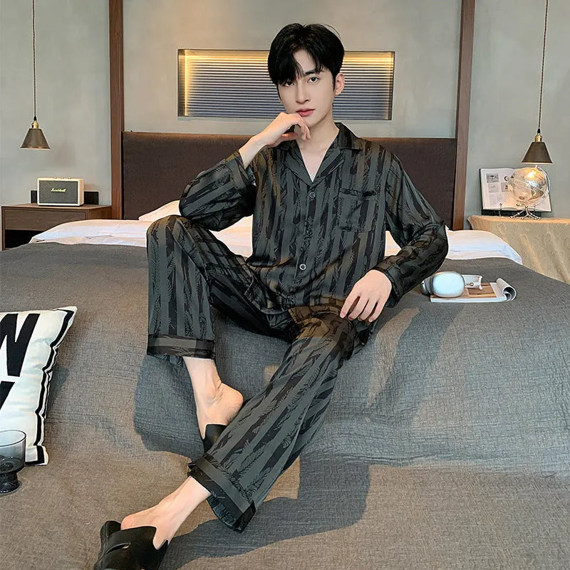 High-grade ice silk men's pyjama set V-neck long sleeve top and thin trousers in black stripes on a neutral background