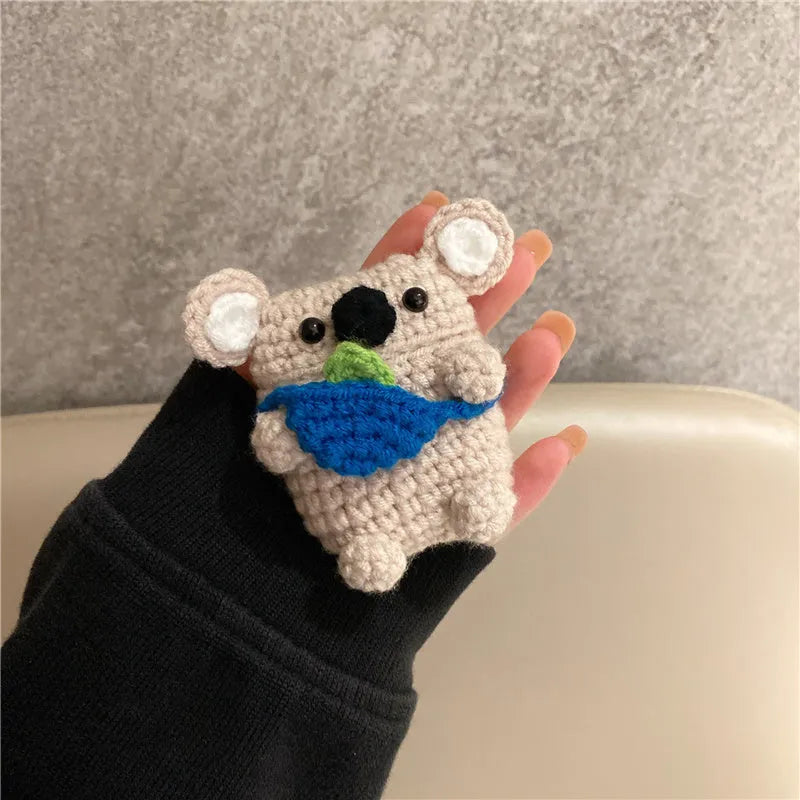 Hand-knitted koala bear backpack design cover for Apple AirPods charging case on a white background.