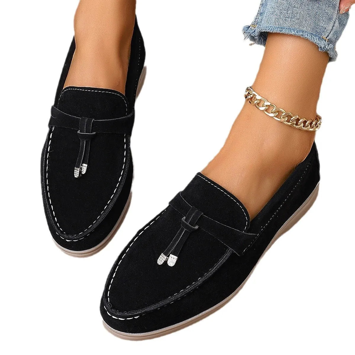 A pair of slip-on canvas loafers with a platform heel and round toe in a solid colour.