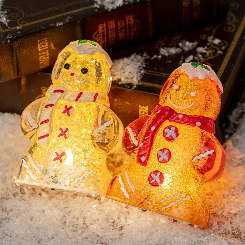 Glowing LED gingerbread man snowman Christmas ornament with a red scarf, measuring 6.5cm by 4cm by 10.5cm.