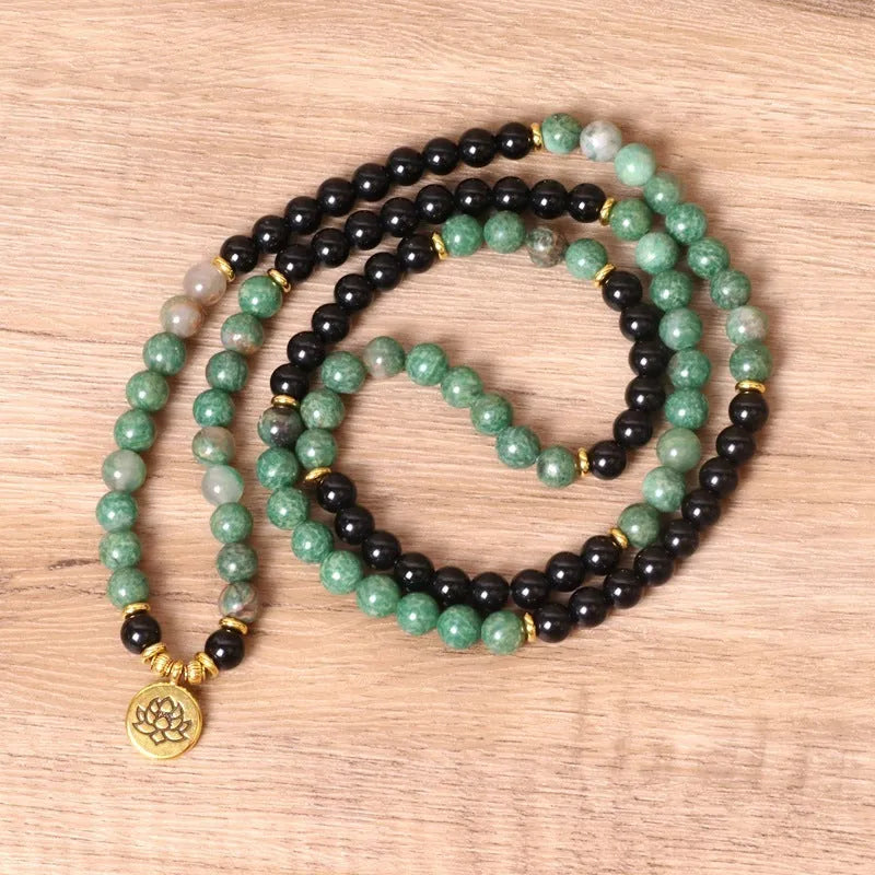 Green and black elastic beaded alloy bracelet with stretch design on wrist
