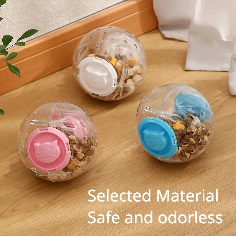 Blue slow feeding ball for cats and small dogs, 11.5cm ABS treat dispenser on floor